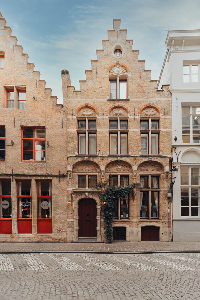 Hotel Malleberg historic brick façade on Hoogstraat in Bruges, ivy-covered entrance